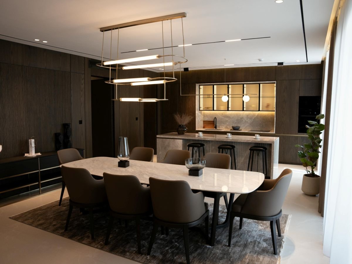 open layout kitchen with porcelain countertops and statement lighting
